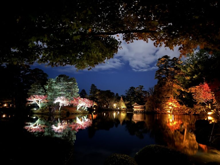 Illuminated Japanese garden at night with reflections, Kotojitoro Lantern, Kanazawa, Ishikawa Prefecture, Japan.
