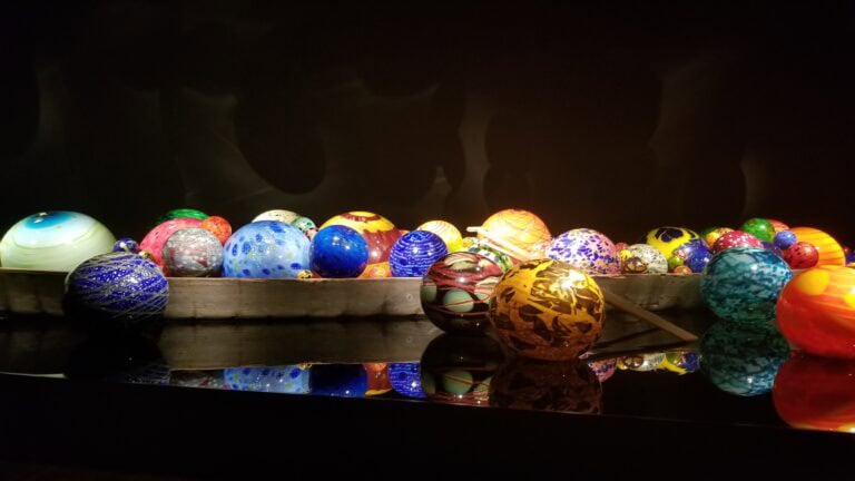 A row of colorful eggs are displayed on a table.