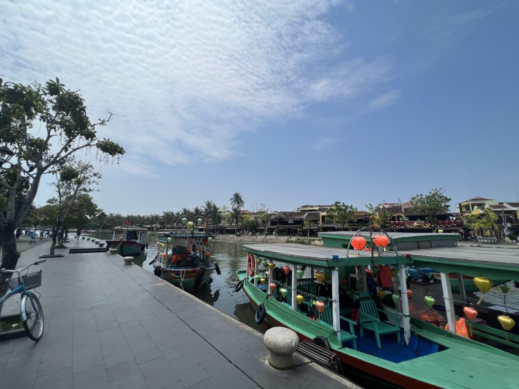 Traditional boats along a riverfront town, Hoi An, Vietnam.