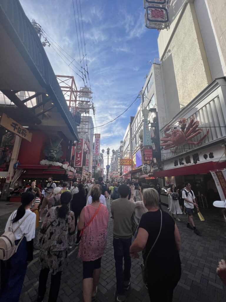 Crowded Dotonbori street with giant crab and dragon, Osaka, Osaka Prefecture, Japan.