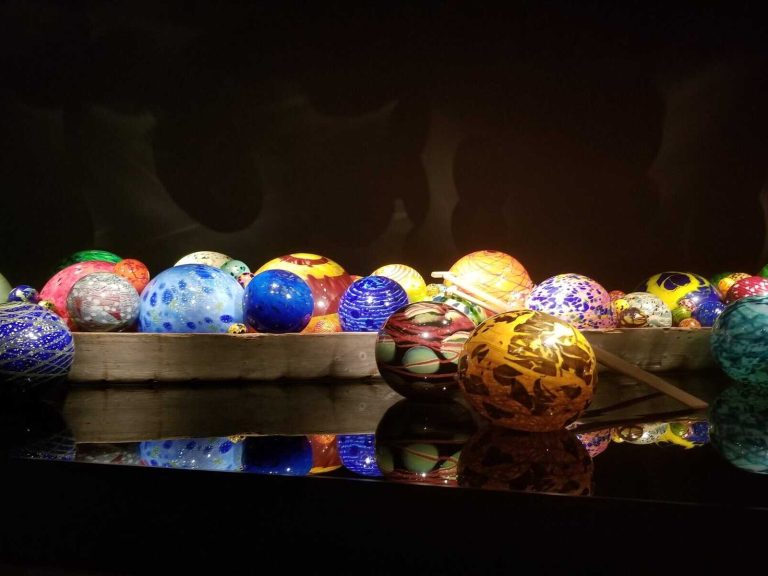 A row of colorful eggs are displayed on a table.