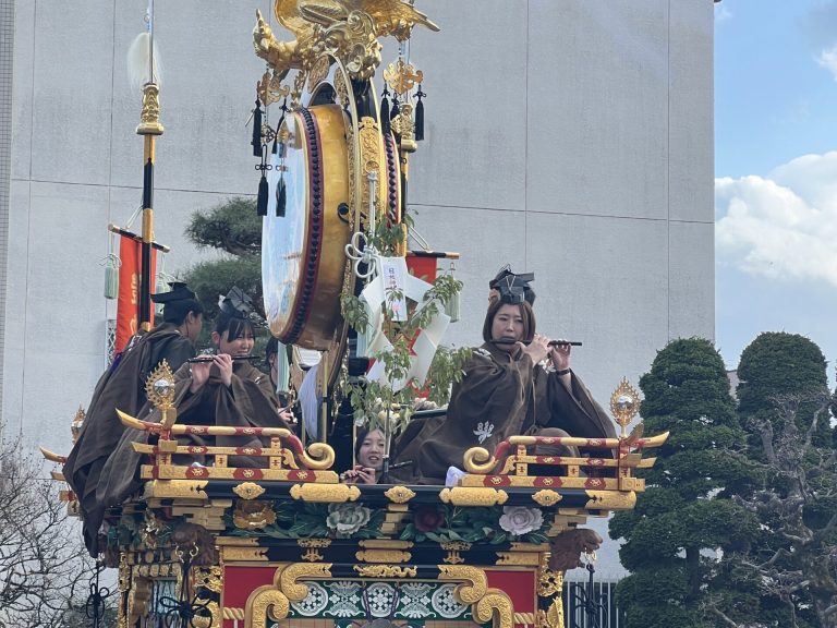 Ornate Japanese festival float with musicians and golden phoenix, Takayama, Gifu Prefecture, Japan.